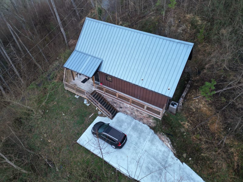 Directly overhead view of the A-frame cabin’s completed standing seam metal roof