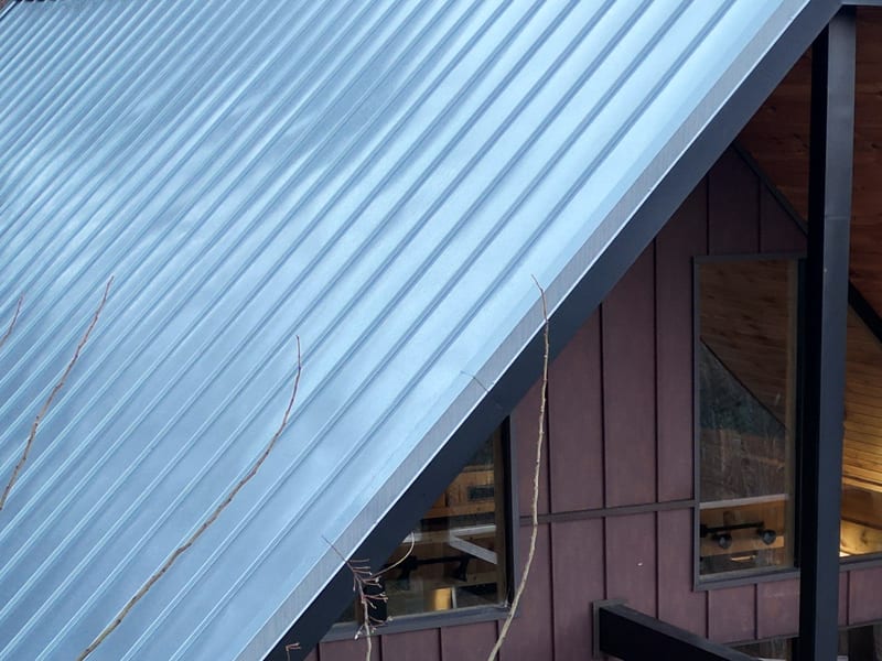 Close view of the metal roof field with the panel ribs running eave to ridge