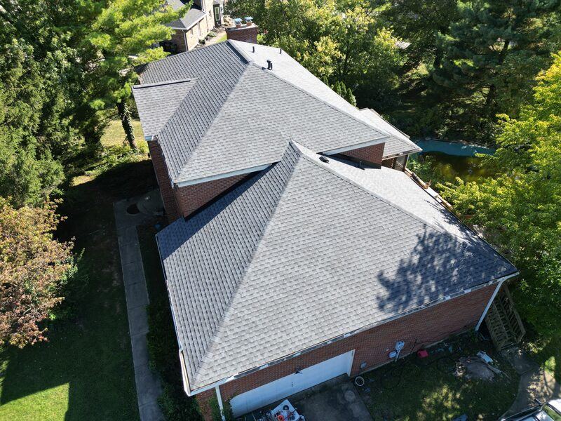 After: completed multi-section roof on brick home