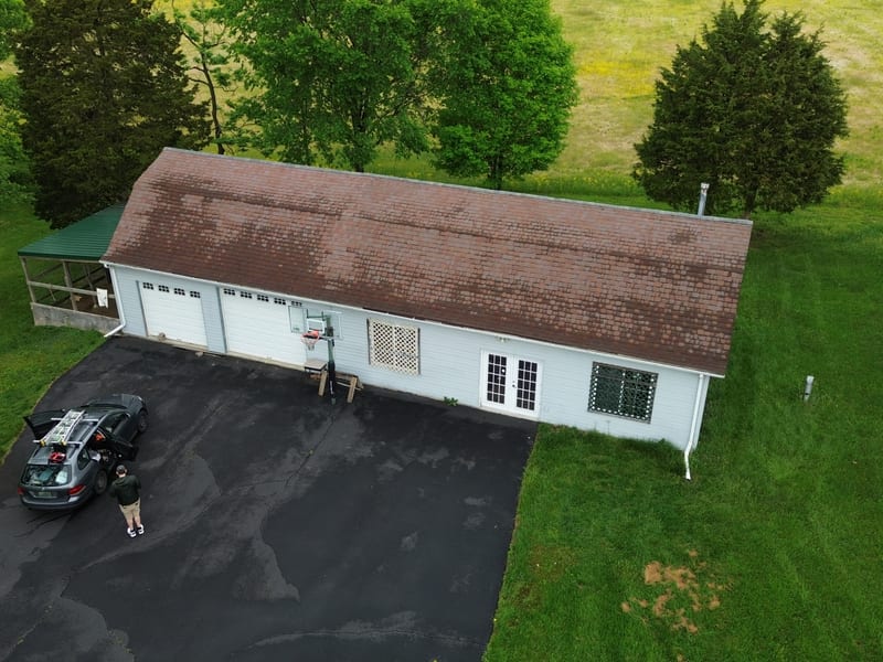Oblique aerial of the completed building with the ridge capped end to end and no aluminum vent remaining