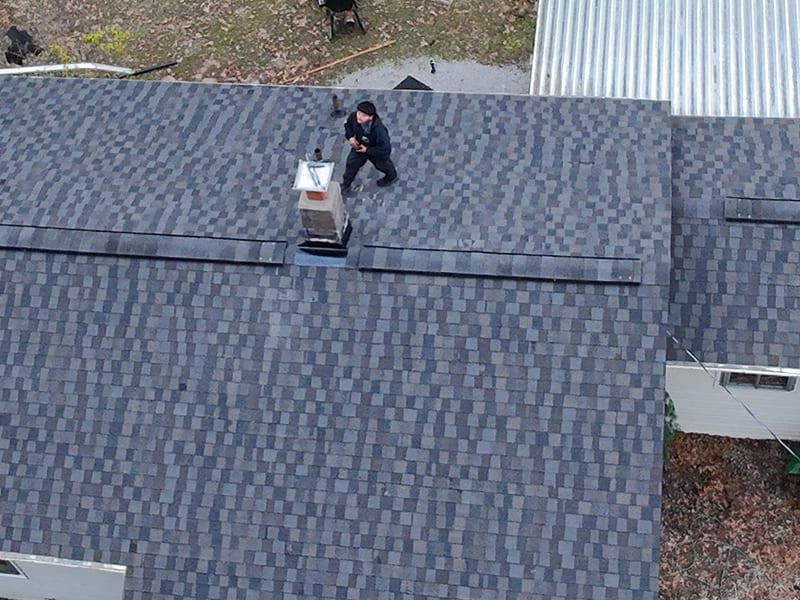Close crop of the finished ridge line with new ridge vent and re-flashed chimney