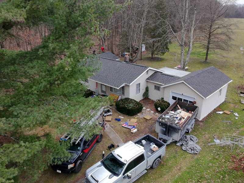 Front elevation of the completed roof across the house and attached garage, shot from the driveway