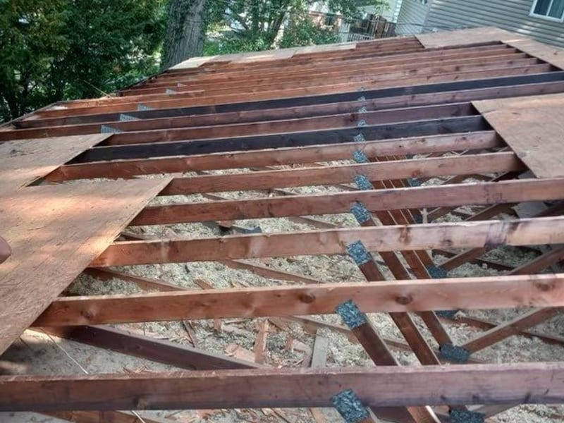 Decking fully stripped with bare rafters and gusset plates open straight to daylight