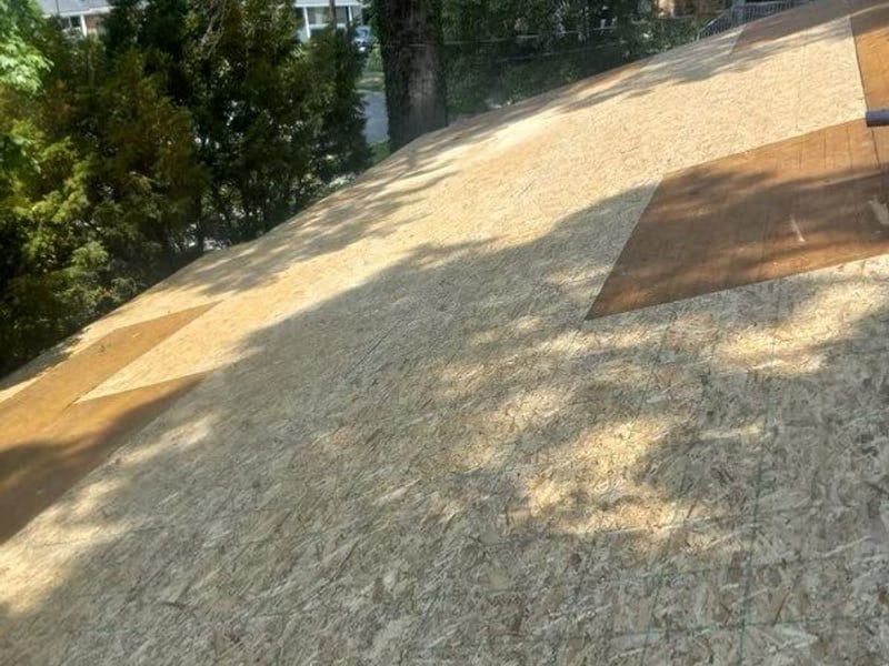 The same slope re-sheathed in clean new decking with chalk lines snapped, ready for underlayment