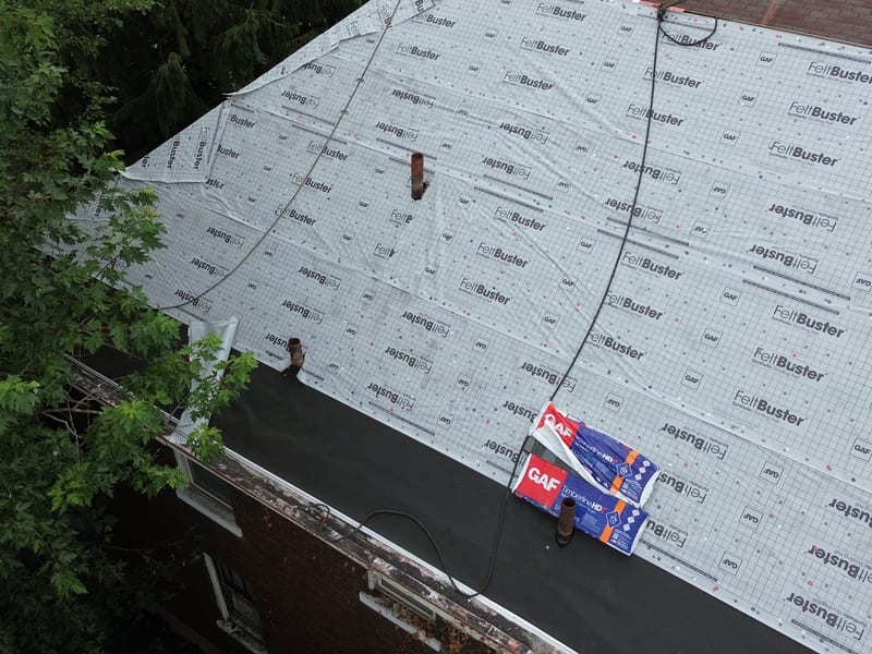 The whole deck dried in under synthetic underlayment with the chimney prepped and shingle bundles staged