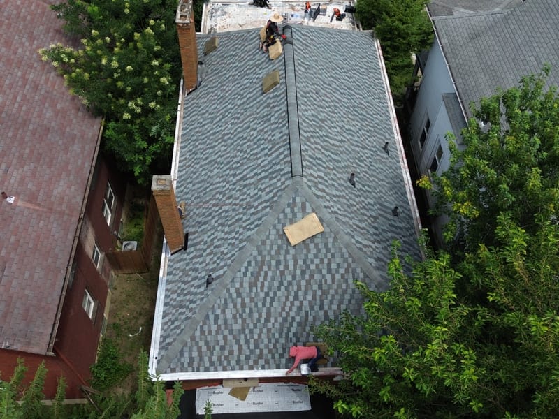 Straight-down aerial with roughly two thirds of the new slate-blend architectural shingle laid