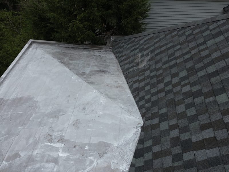 The steep-to-low-slope transition with fresh silver reflective coating over the flat section