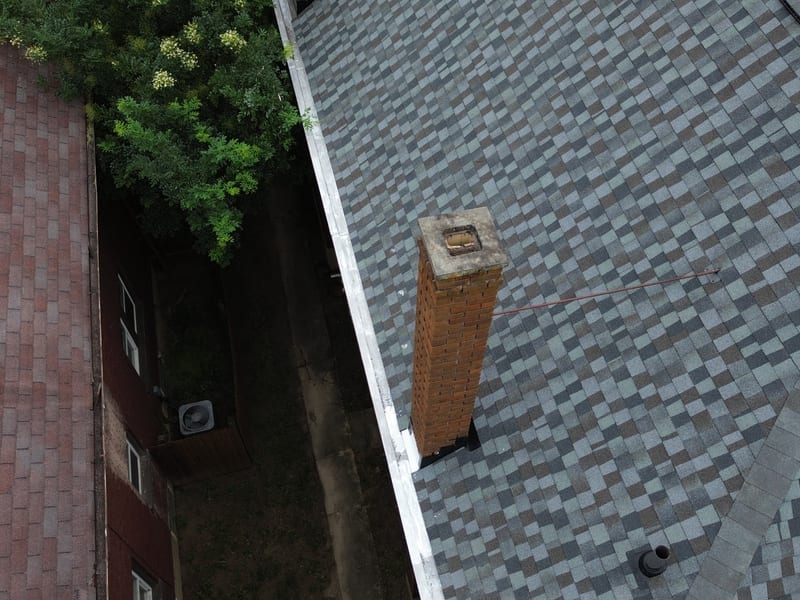 Top-down on the tall brick chimney with its new step and counter flashing complete