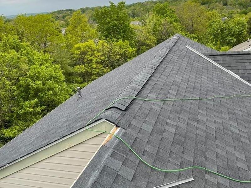 The finished charcoal roof looking down the ridge with the wooded river valley opening up behind