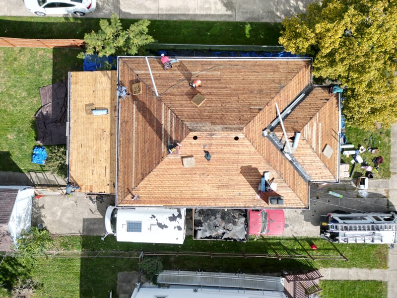 Straight-down view of the same deck where the plank courses and a new sheathing section split the frame