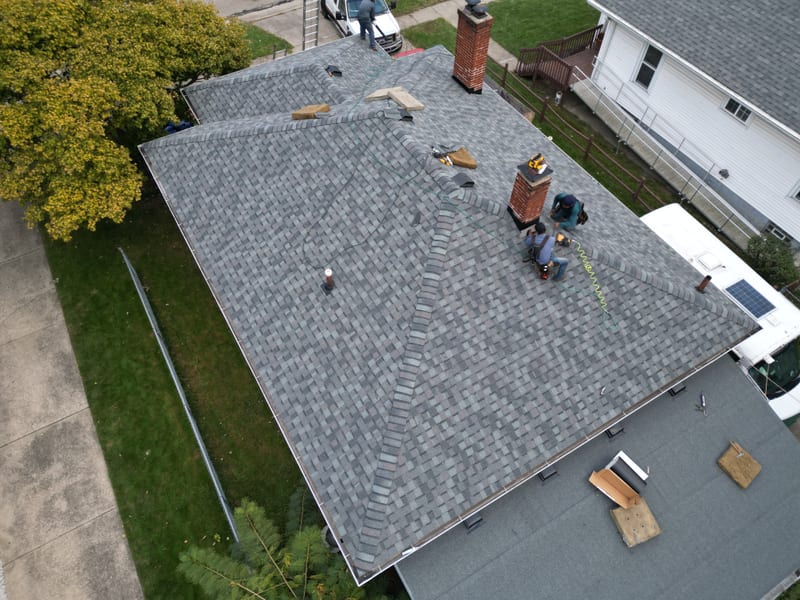 The finished roof seven hours later in grey architectural laminate with crisp hip and ridge cap lines
