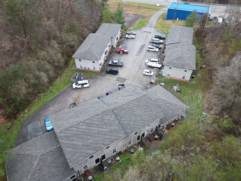 Aerial drone view of completed multi-building apartment complex with new roofs
