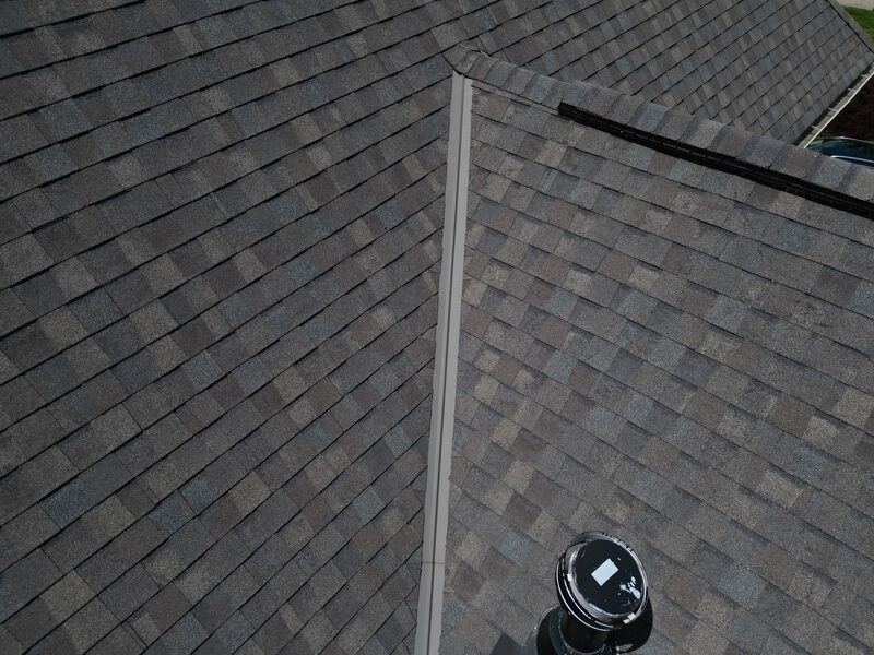 Clean metal valley flashing with new architectural shingles on both sides