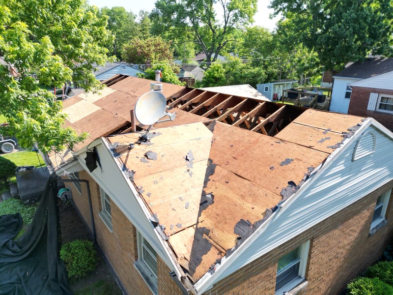 Oblique aerial of the brick ranch with its rear slope opened to the rafters