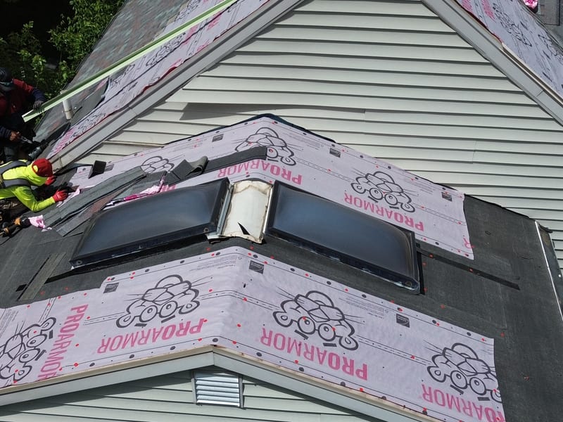 Synthetic underlayment and ice-and-water membrane down over the octagonal bay with both skylights re-set and ready to flash