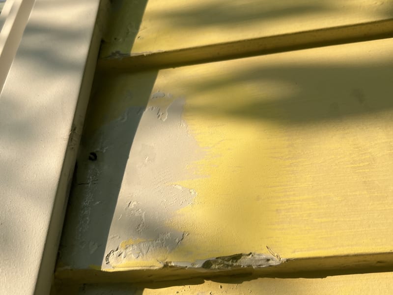 Exterior wood filler packed into the cavity and sanded flush with the board profile