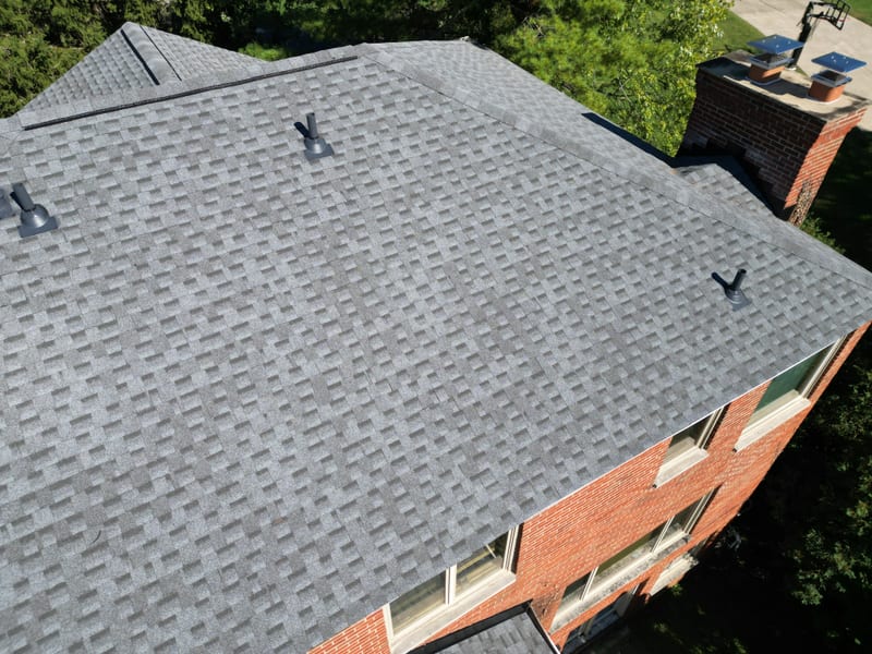 Finished main roof plane with new pipe boots and the rebuilt chimney with its new caps